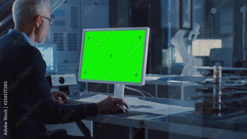 Poster professional heavy industry engineer works on green mock-up screen computer. engineering bureau and 