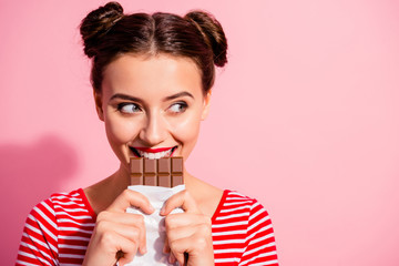 Close-up portrait of her she nice cute charming attractive glamorous cheerful sly cunning hungry girl in striped t-shirt biting tasting eating desirable favorite dessert isolated on pink background - obrazy, fototapety, plakaty