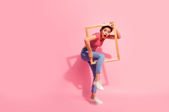 Full length body size view of her she nice cute charming attractive glamorous worried girl in casual striped t-shirt jeans trying to escape break rules borders life isolated over pink background
