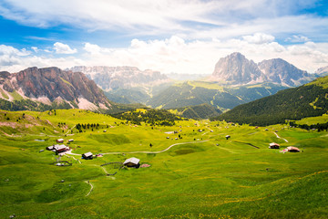 Fototapeta na wymiar beautiful view of a green valley and dolomites mountains during summer in val gardena, saslong, south tyrol