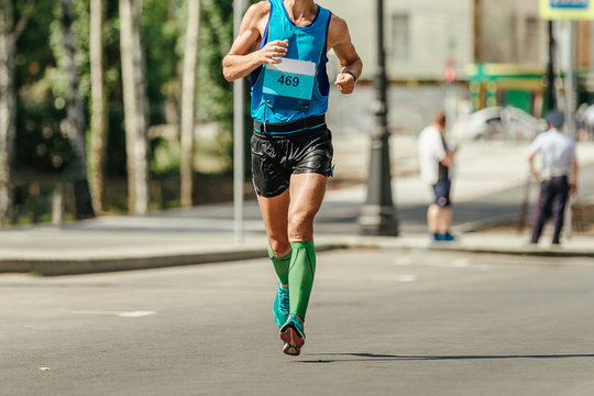 Man Runner In Compression Socks Running Marathon In Hot Weather