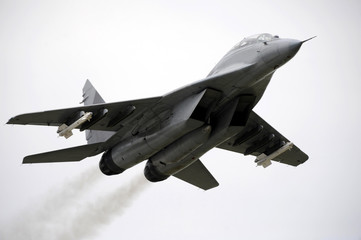 Fighter jet armed with air to air missiles fly over