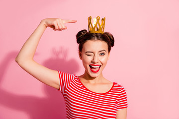 Close-up portrait of her she nice cute attractive lovely winsome gorgeous cheerful cheery glad flirty girl wearing striped t-shirt showing cool gold diadem isolated over pink pastel background © deagreez