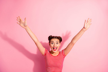 Portrait of her she nice-looking cute charming attractive glamorous cheerful cheery girl wearing striped t-shirt raising hands up having fun isolated over pink pastel background