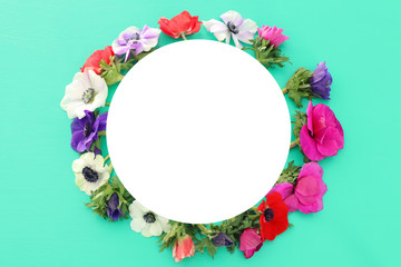 Top view of empty sircle over anemone spring flowers. Flat lay
