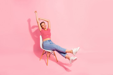 Nice-looking attractive winsome lovely adorable cheerful girl wearing striped tshirt jeans lying on...