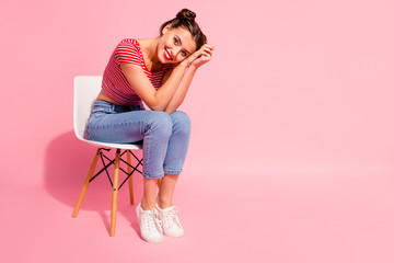 Fototapeta na wymiar Nice-looking cute sweet attractive glamorous winsome lovely shine cheerful girl wearing striped tshirt jeans sitting on chair having free spare time isolated over pink pastel background