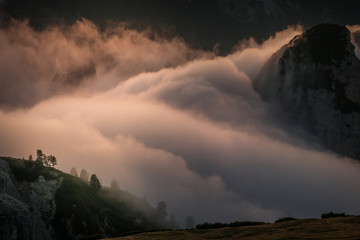 majestic view of Dolomites mountains above the clouds during sunset at 2500m