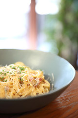 Spaghetti white sauce (Spaghetti Carbonara) with bacon and garlic , on wood table background