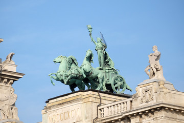 Obraz premium Statues on roof of Museum of Ethnography in Budapest, Hungary. The building located at Kossuth Square, across from the Hungarian Parliament