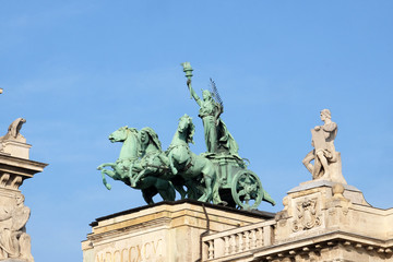 Fototapeta na wymiar Statues on roof of Museum of Ethnography in Budapest, Hungary. The building located at Kossuth Square, across from the Hungarian Parliament