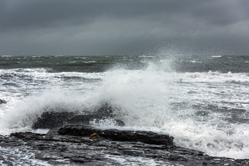 Fototapeta premium Splash of huge waves on a rocky shore