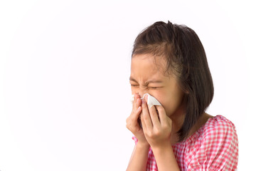 Portrait of cute little girl blowing nose in paper handkerchief,Asian girl sneezing in a tissue isolated on white background,hay fever, runny nose,concept of pollution,dust allergies