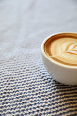 cappuccino or Latte art coffee made from milk on the wood table in coffee shop