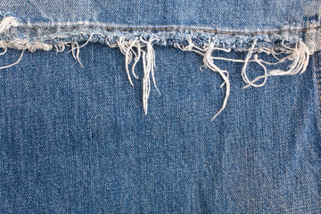 torn old blue jeans background