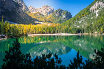 amazing view of braies lake with wooden boats on the water, surrounded by dolomites mountains. Trentino alto adige, Italy