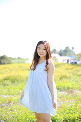 Fototapeta na wymiar Portrait of Young Asian woman girl smile in flower garden