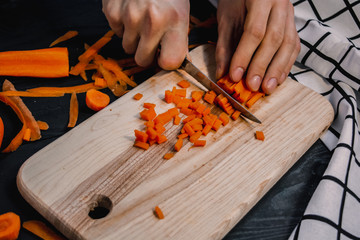 Cutting carrot in brunoise dice. Chef cooking. Types of cuts.