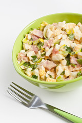 Egg salad in a green bowl with fork