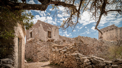 Alley in abandoned village and ruins of fortress Kato Chora on the island Kythyra, Greece under a...