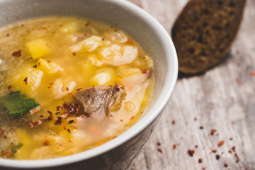 Fat meat soup with lamb based broth, chickpea and potatoes. Selective focus.