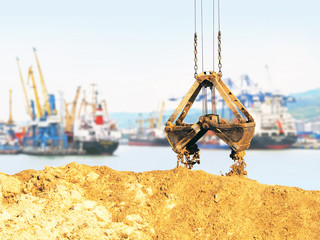Cargo sea port, work. Unloading sand. Grapple lifting device for port cranes for bulk materials,...