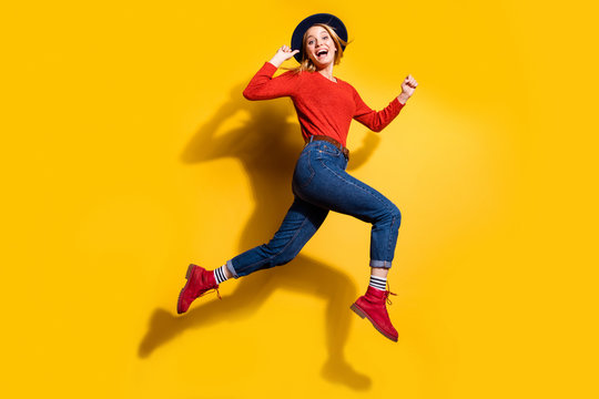 Profile side full length body size view of her she nice attractive lovely fascinating fashionable cheerful cheery girl having fun running isolated over bright vivid shine orange background