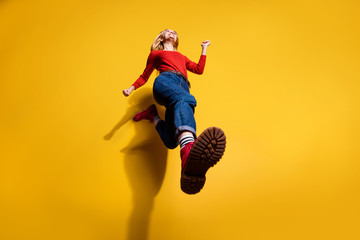 Low below angle full length body size view of nice attractive cheerful girl having fun going making step wearing vintage retro maroon boots isolated over bright vivid shine orange background - obrazy, fototapety, plakaty
