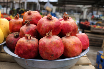 Red pomegranates for sale at a fruit market