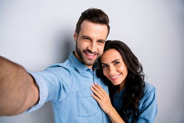 Close up portrait two amazing she her he him his couple lady guy couple make take selfies wife husband valentine day wear casual jeans denim shirts outfit clothes isolated light grey background