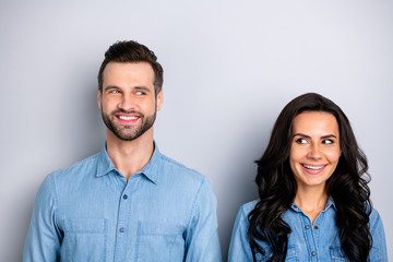 Portrait of two affectionate pretty modest students workers meeting feeling carefree positive isolated dressed in blue denim outfit on silver background