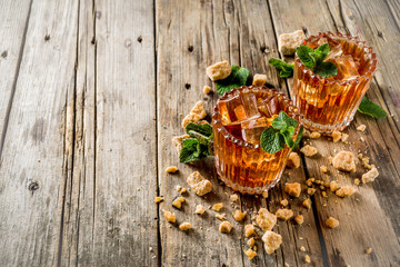 Summer iced mint tea. Traditional Moroccan drink  with mint. Rustic wooden background, copy space