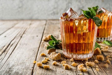 Summer iced mint tea. Traditional Moroccan drink  with mint. Rustic wooden background, copy space