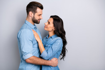 Profile side view photo of charming handsome affectionate casual spouses married delighted dressed in blue denim clothing isolated on grey background