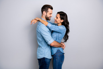 Photo profile side view of comfort cozy beautiful couple affectionate passionate delighted in denim clothing isolated on silver background