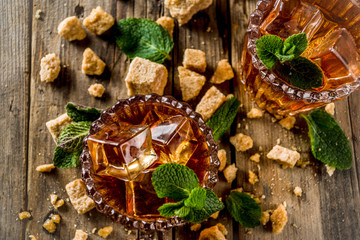 Summer iced mint tea. Traditional Moroccan drink  with mint. Rustic wooden background, copy space