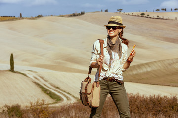 happy solo traveller woman with smartphone using applications