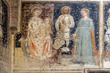 Enthroned Madonna and Child, Saints George, Catherine and a worshipper Knight, fresco in the church of San Pietro Martire in Verona, Italy