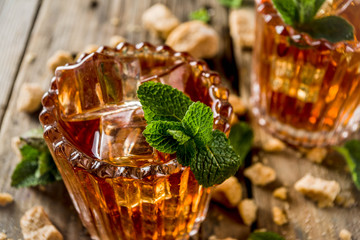 Summer iced mint tea. Traditional Moroccan drink  with mint. Rustic wooden background, copy space