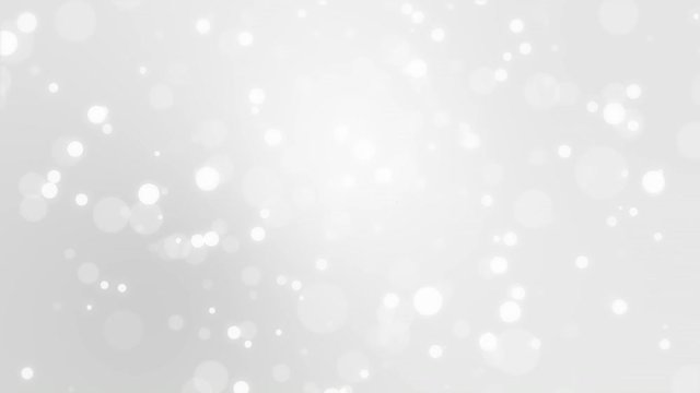 Glowing silver white bokeh background with floating light particles.