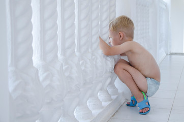 child looks from the balcony