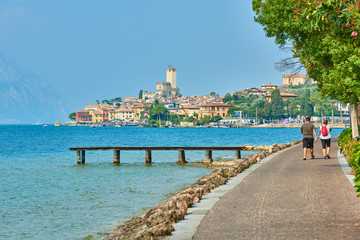 Obraz premium View of the beautiful Lake Garda in Veneto region, Malcesine town and old castle on rock in the summer time , Italy