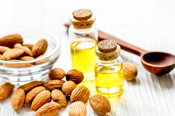 cosmetic set with almond oil on wooden table background