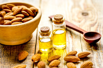 organic cosmetic with almond extract on table background