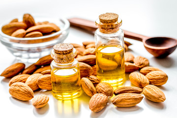 organic cosmetic with almond extract on table background