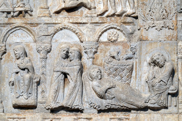 Annunciation, Visitation and Birth of Jesus, medieval relief on the facade of Basilica of San Zeno in Verona, Italy