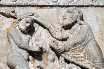 Baptism of the Christ, medieval relief on the facade of Basilica of San Zeno in Verona, Italy