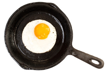 Fried chicken egg on iron pan. Top view, isolated on white background