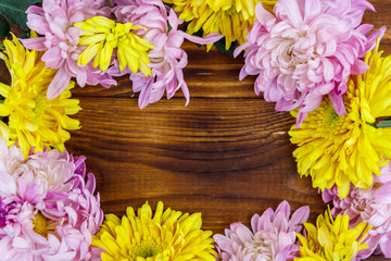 Beautiful chrysanthemums on wooden background. Top view, copy space