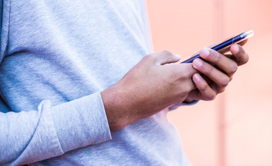 Close-up of a mobile phone in the hands of a black man. Smartphone uses. 